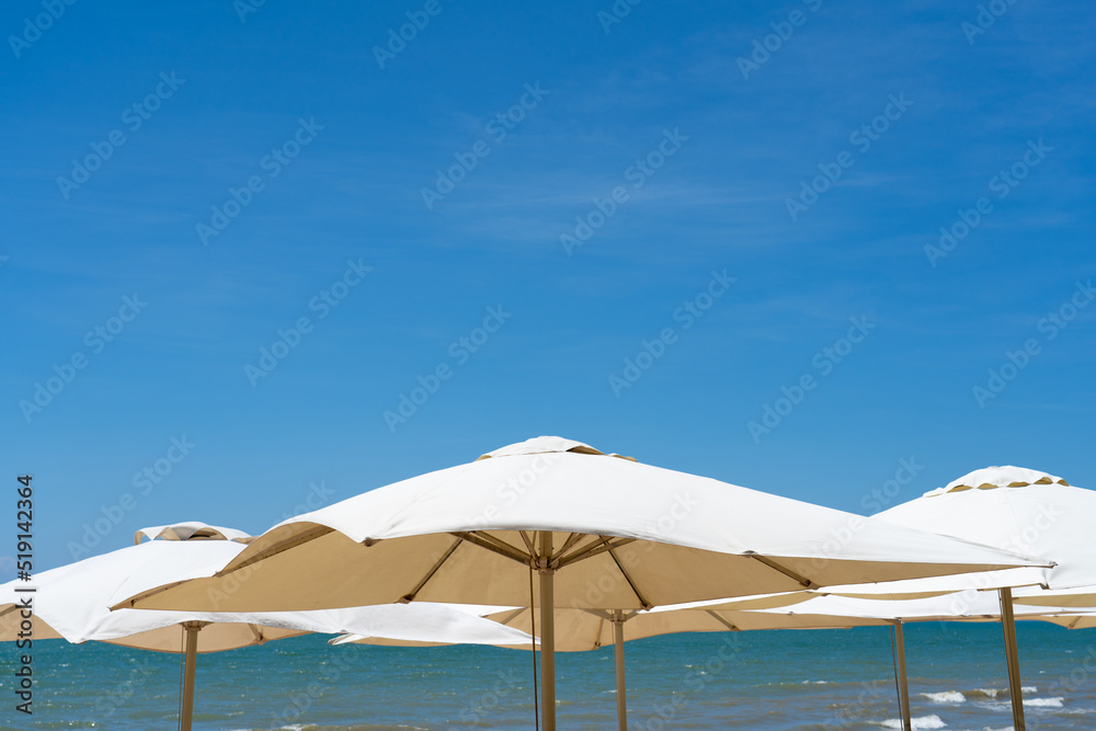 Beach umbrellas are spreading on the beach by the sea