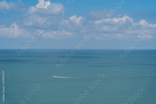A speedboat is sailing in the ocean.