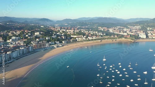 Unique cinematic perspective of the European city SAN SEBASTIAN. Situated in Spain -Vesque Country is a famous travel destination. Drone rotating around the Statue of Jesus. Panoramic view of the city photo