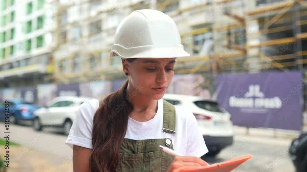 Woman construction engineer wear safety hard hat at construction site. Woman construction engineer wear safety hard hat at construction site.