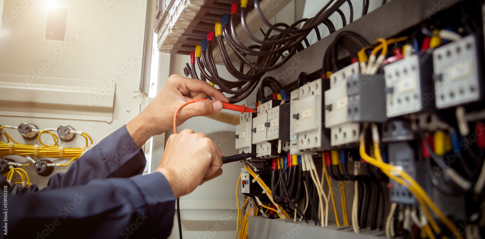 Electrical engineer using measuring equipment to checking electric current voltage at circuit breaker and cable wiring system , Electrical service concept . Electrical engineer using measuring equipment to checking electric current voltage at circuit breaker and cable wiring system , Electrical service concept .