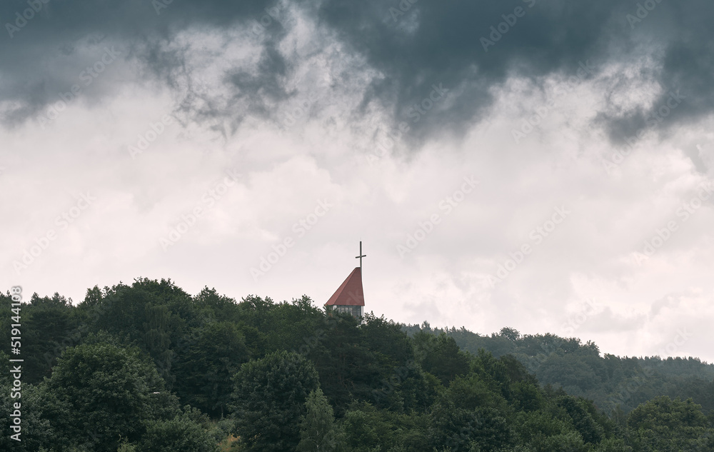 Big church in the forest. Christian cross over the trees with the epic sky above. Big church in the forest. Christian cross over the trees with the epic sky above.