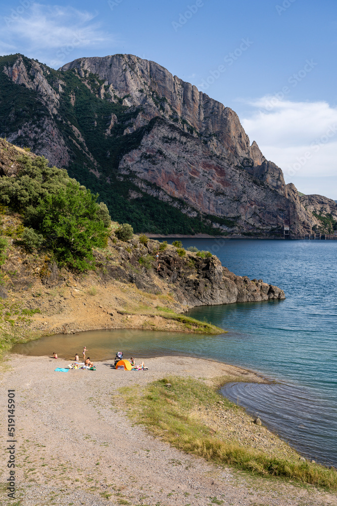 bathers on the beach of Ermita de Santa Justa or San Clemente, Escales reservoir, Noguera Ribagorzana, Huesca, Spain