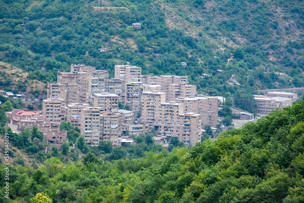 High-rise buildings of the city on the mountains. City in nature. Beautiful nature and city
