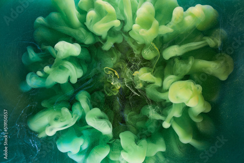 Liquid fluid art abstract background. Green dancing acrylic paints underwater, cosmic smoke ocean
