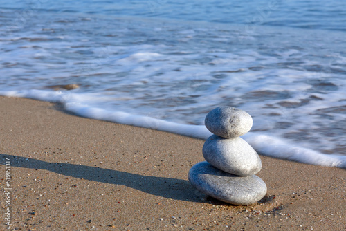 Spa background with zen stones on beach.