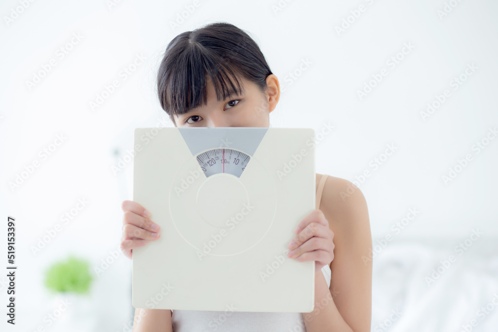 Portrait of beautiful young asian woman holding scales with confident with control and weightloss, girl dieting for result of weight loss with satisfied, one person, healthy and lifestyles concepts. Portrait of beautiful young asian woman holding scales with confident with control and weightloss, girl dieting for result of weight loss with satisfied, one person, healthy and lifestyles concepts.