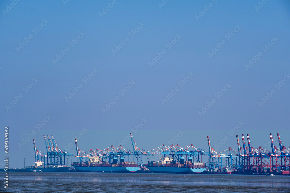 View across the Weser to the container port of Bremerhaven/Germany with three container ships