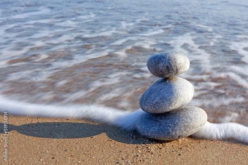 Spa background with zen stones on beach.