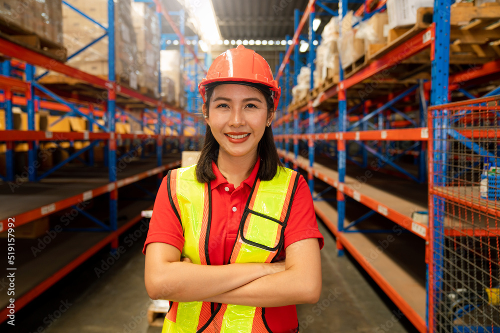 Portrait of female supervisor standing in warehouse with his arm crossed looking at camera. Portrait of female supervisor standing in warehouse with his arm crossed looking at camera.