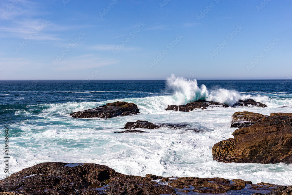 A view on Pacific ocean, cast, rocks and waves