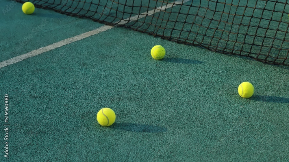4K. Close-up of tennis balls on the grass on the court