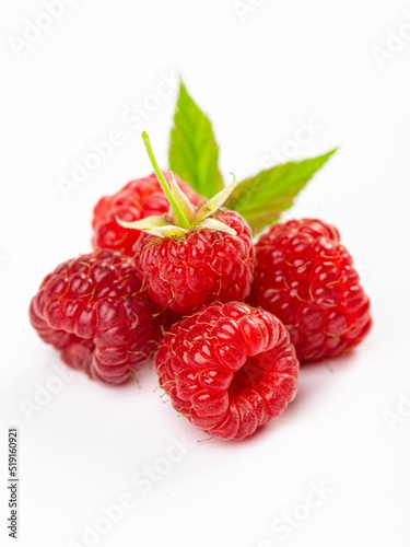 Isolated berries. Bunch of raspberry fruits with leaves isolated on white background with clipping path