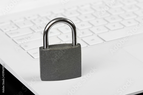 Padlock on a laptop as a concept of protecting information in cyberspace