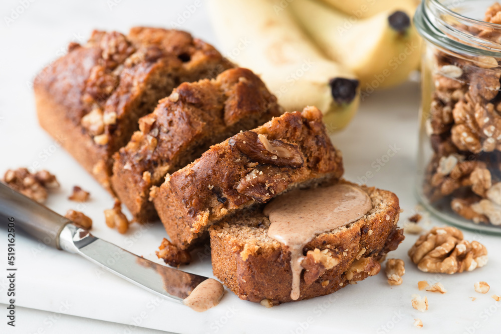 Vegan gluten free Banana bread with walnuts cut into slices, closeup view