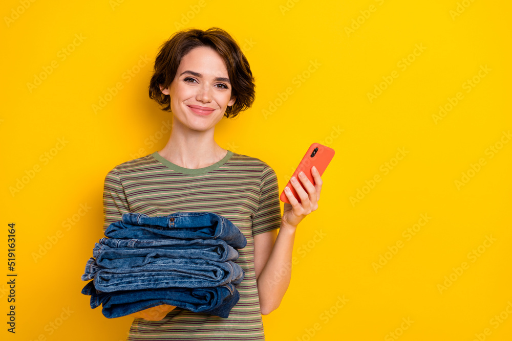 Photo of sweet cute girl dressed green t-shirt selling clothes modern gadget empty space isolated yellow color background Photo of sweet cute girl dressed green t-shirt selling clothes modern gadget empty space isolated yellow color background