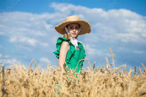 Young blonde model in wheat field