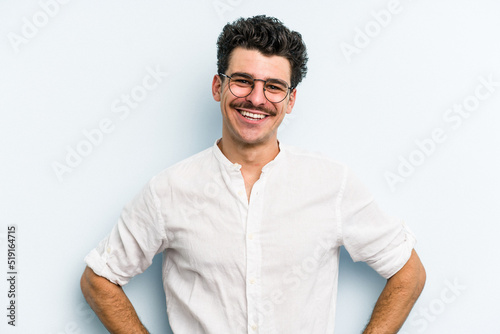 Young caucasian man isolated on blue background happy, smiling and cheerful.