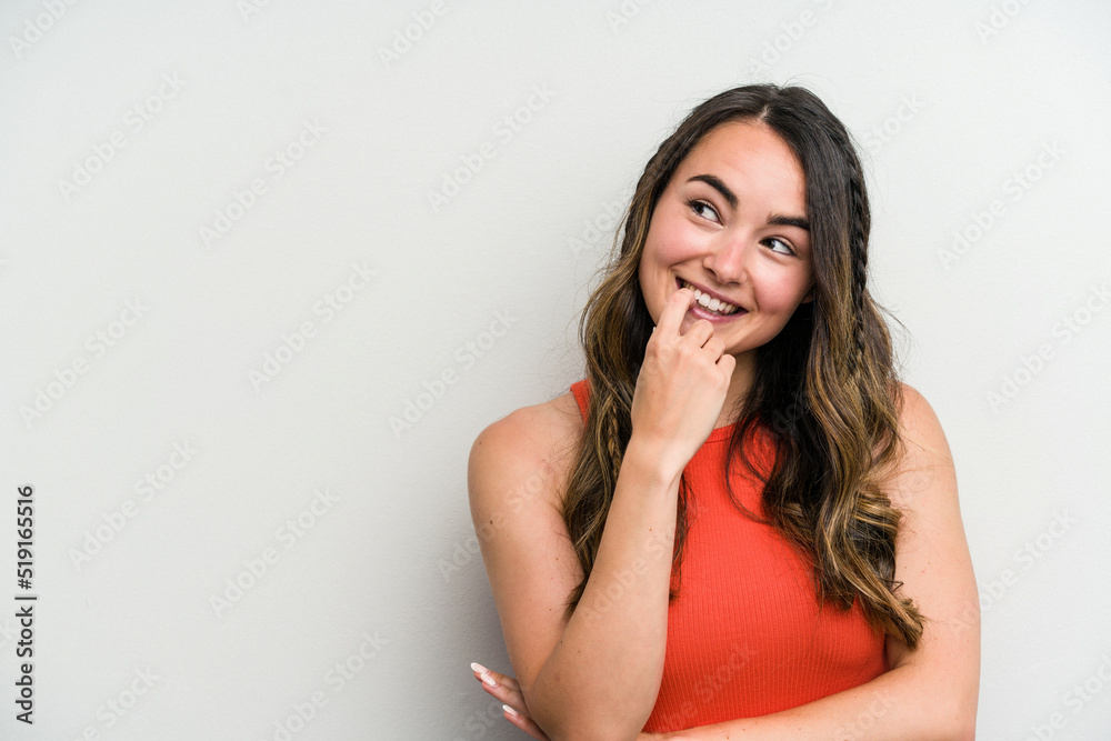 Young caucasian woman isolated on white background relaxed thinking about something looking at a copy space. Young caucasian woman isolated on white background relaxed thinking about something looking at a copy space.