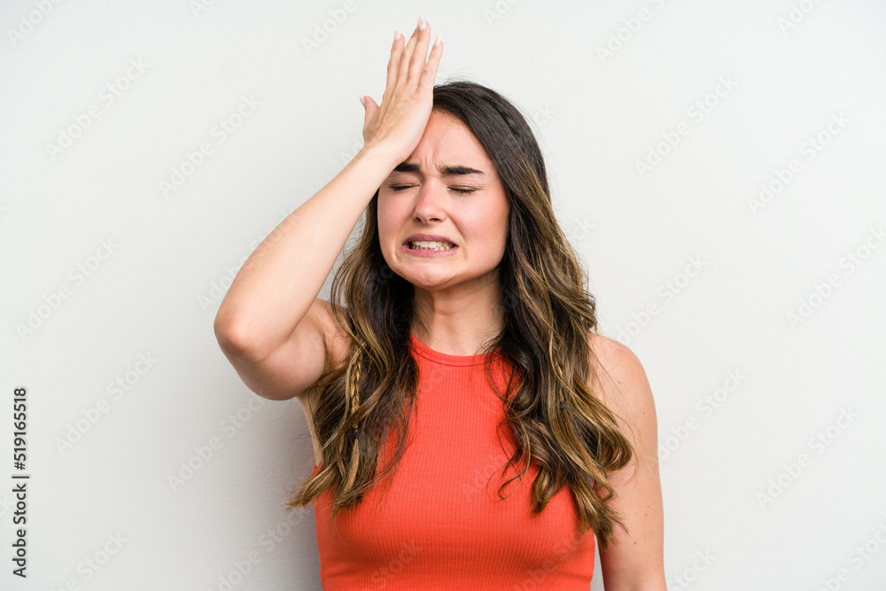 Young caucasian woman isolated on white background forgetting something, slapping forehead with palm and closing eyes.