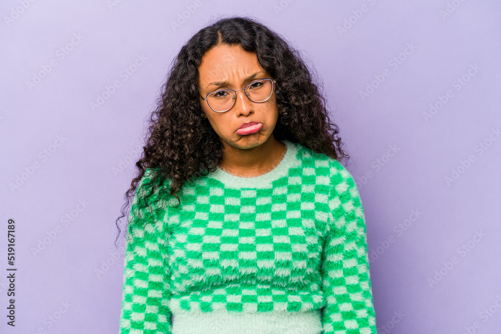 Young hispanic woman isolated on purple background sad, serious face, feeling miserable and displeased. Young hispanic woman isolated on purple background sad, serious face, feeling miserable and displeased.