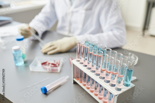 Close up image of test tube set and equipments on table in medical laboratory with technician working  copy space