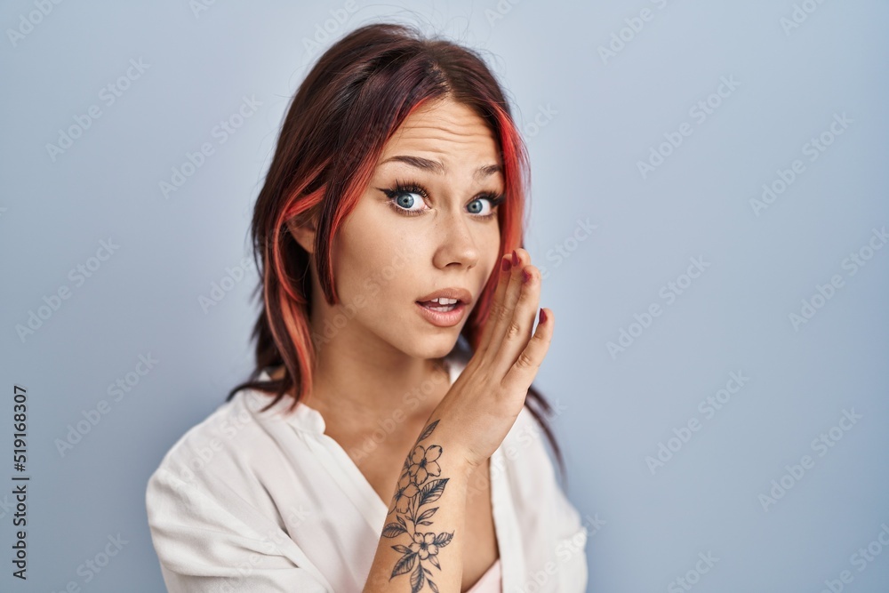 Young caucasian woman wearing casual white shirt over isolated background hand on mouth telling secret rumor, whispering malicious talk conversation Young caucasian woman wearing casual white shirt over isolated background hand on mouth telling secret rumor, whispering malicious talk conversation