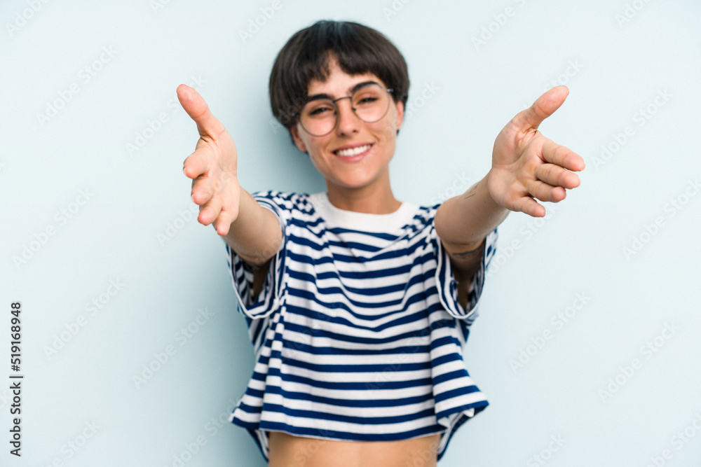 Young caucasian woman with a short hair cut isolated feels confident giving a hug to the camera. Young caucasian woman with a short hair cut isolated feels confident giving a hug to the camera.