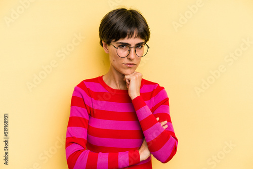 Young caucasian woman with a short hair cut isolated thinking and looking up, being reflective, contemplating, having a fantasy.