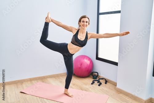 Young woman smiling confident training yoga at sport center