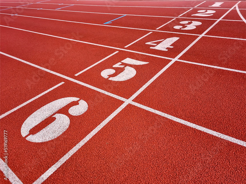 Red running tracks in the athletics stadium. Background image of empty tracks for running. © alzay