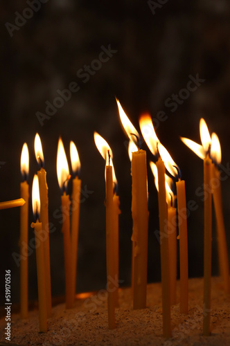 Wax candle burning in the church.