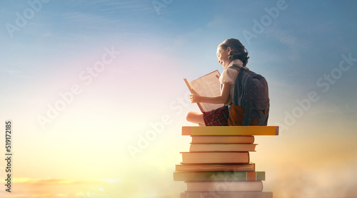 child on the tower of books photo