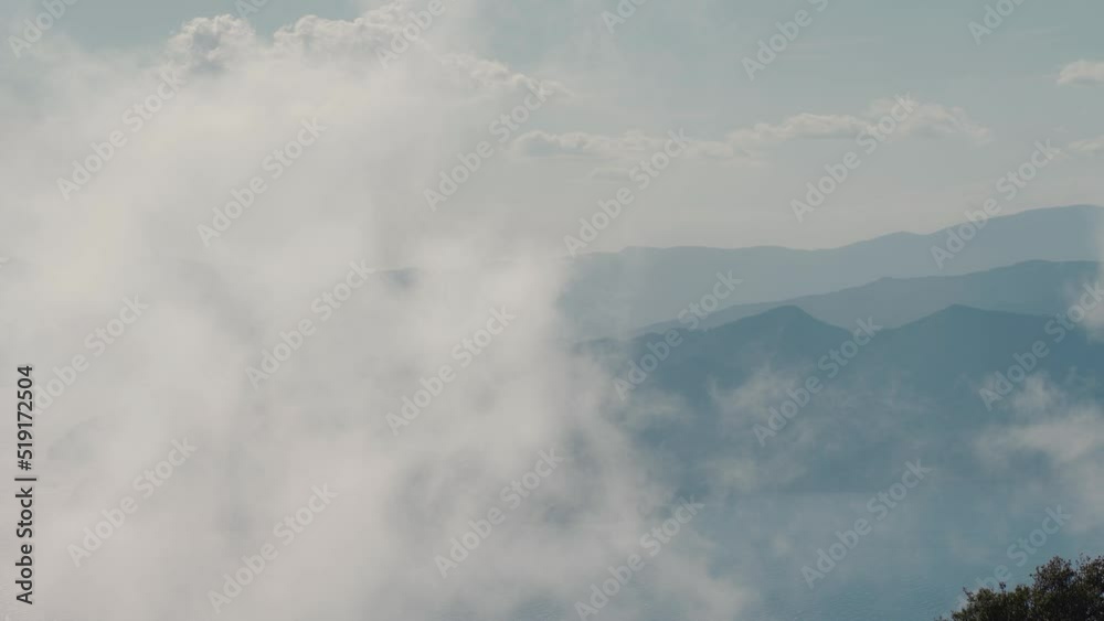 view from a high mountain to the rocky steep coast of the Aegean Sea in Turkey. Summer vacation and travel in Turkey. fog and clouds moves by wind view from a high mountain to the rocky steep coast of the Aegean Sea in Turkey. Summer vacation and travel in Turkey. fog and clouds moves by wind