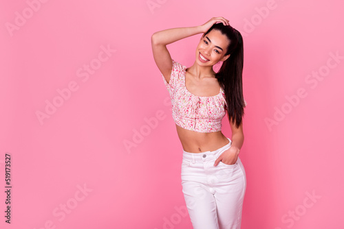 Portrait of positive nice lady hand touch hair posing empty space ad isolated on pink color background