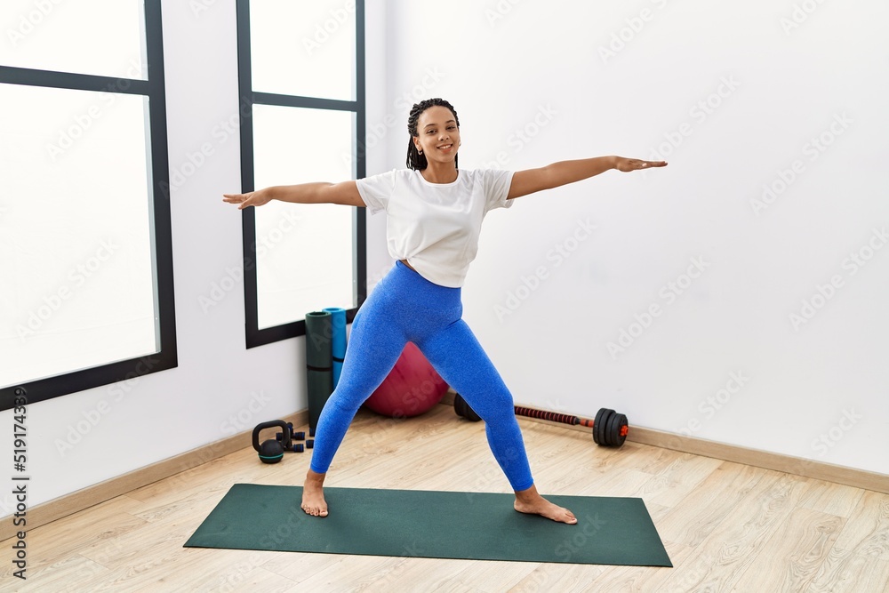 Young african american woman smiling confident training yoga at sport center