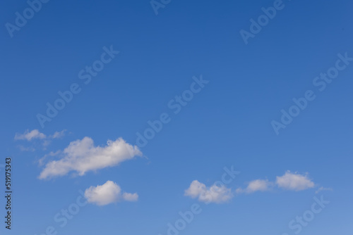 White small clouds float across the bright blue spring sky