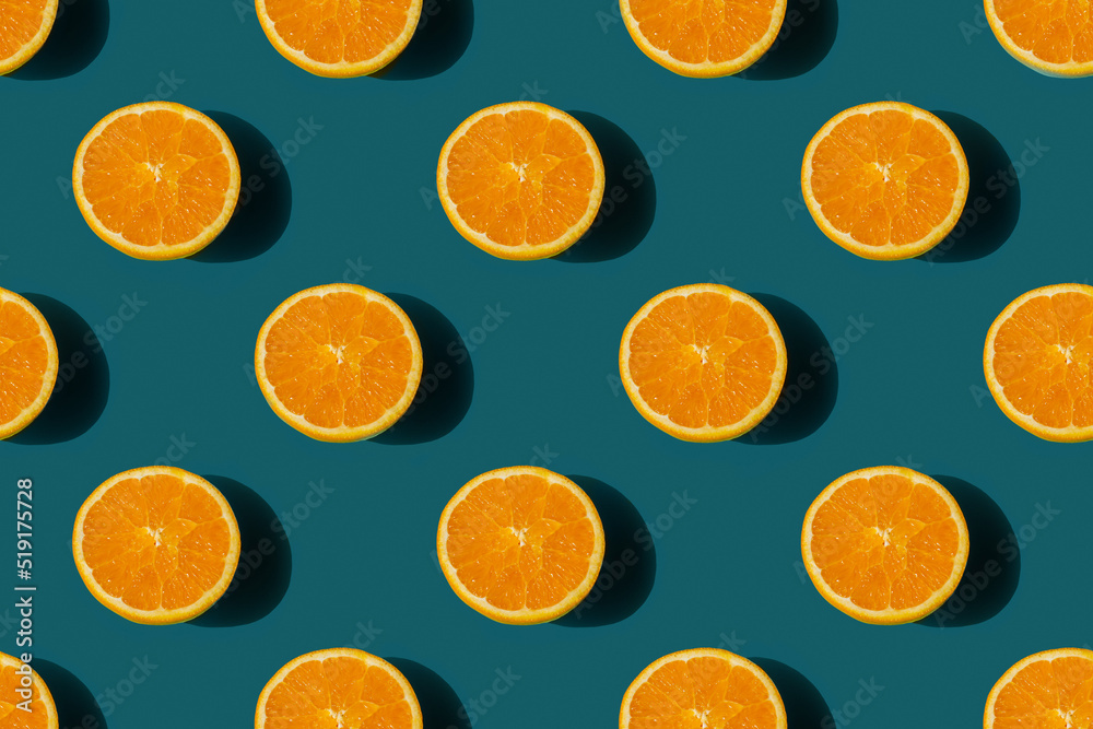 seamless pattern of ripe tasty orange cut in half on a blue background seamless pattern of ripe tasty orange cut in half on a blue background