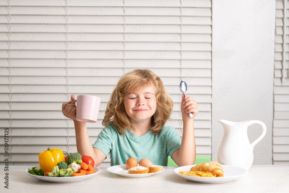 Kid boy eating healthy food vegetables. Breakfast with milk, fruits and vegetables. Child eating during lunch or dinner. Kid boy eating healthy food vegetables. Breakfast with milk, fruits and vegetables. Child eating during lunch or dinner.