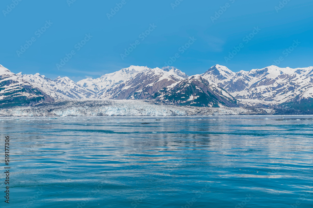 A view across the icy waters of Disenchartment Bay towards in the Valerie Glacier, Alaska in summertime
