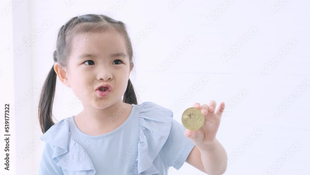 Little asian girl holding bitcoin crypto currency. Little asian girl holding bitcoin crypto currency.