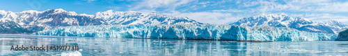 A panorama view past floating ice in Disenchartment Bay towards in the Hubbard Glacier, Alaska in summertime