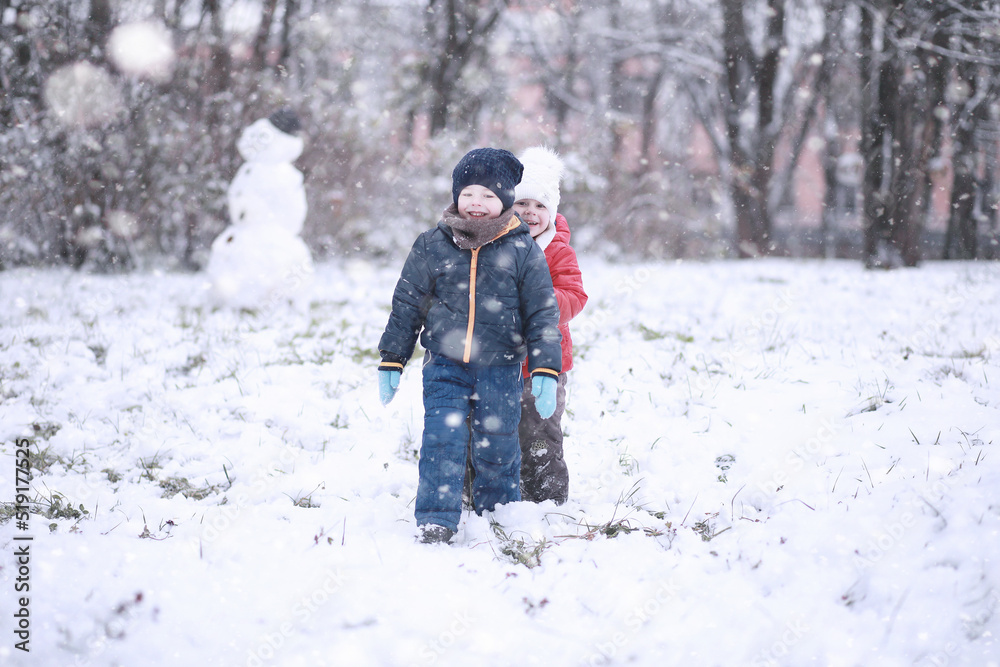 Kids walk in the park first snow