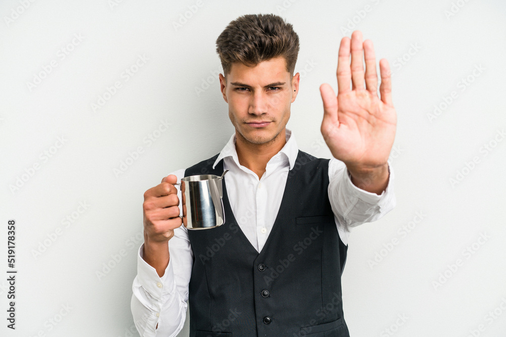 Young caucasian barista man isolated on yellow background standing with outstretched hand showing stop sign, preventing you. Young caucasian barista man isolated on yellow background standing with outstretched hand showing stop sign, preventing you.