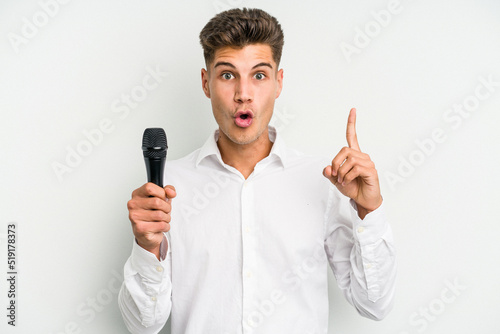 Young singer caucasian man isolated on white background having some great idea, concept of creativity.
