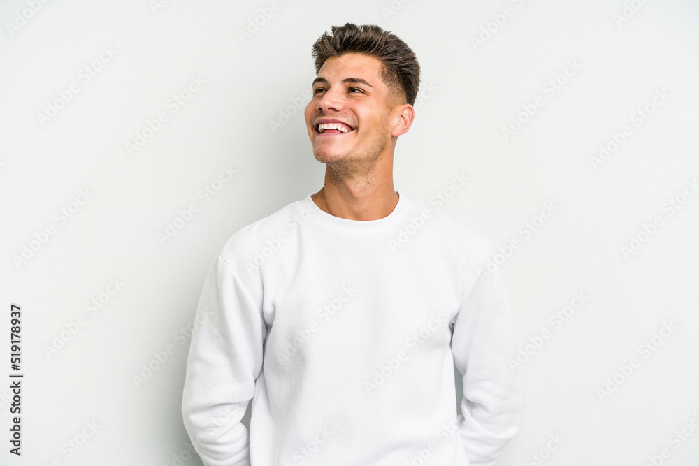 Young caucasian man isolated on white background relaxed and happy laughing, neck stretched showing teeth. - obrazy, fototapety, plakaty 