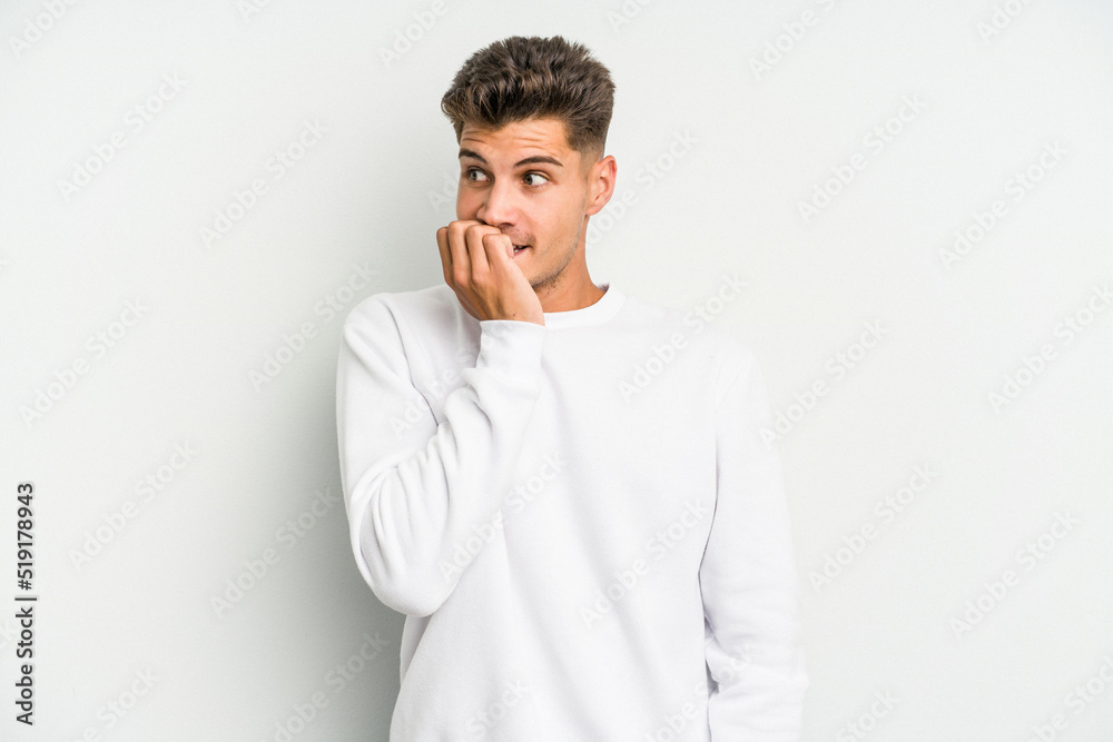 Young caucasian man isolated on white background biting fingernails, nervous and very anxious. Young caucasian man isolated on white background biting fingernails, nervous and very anxious.