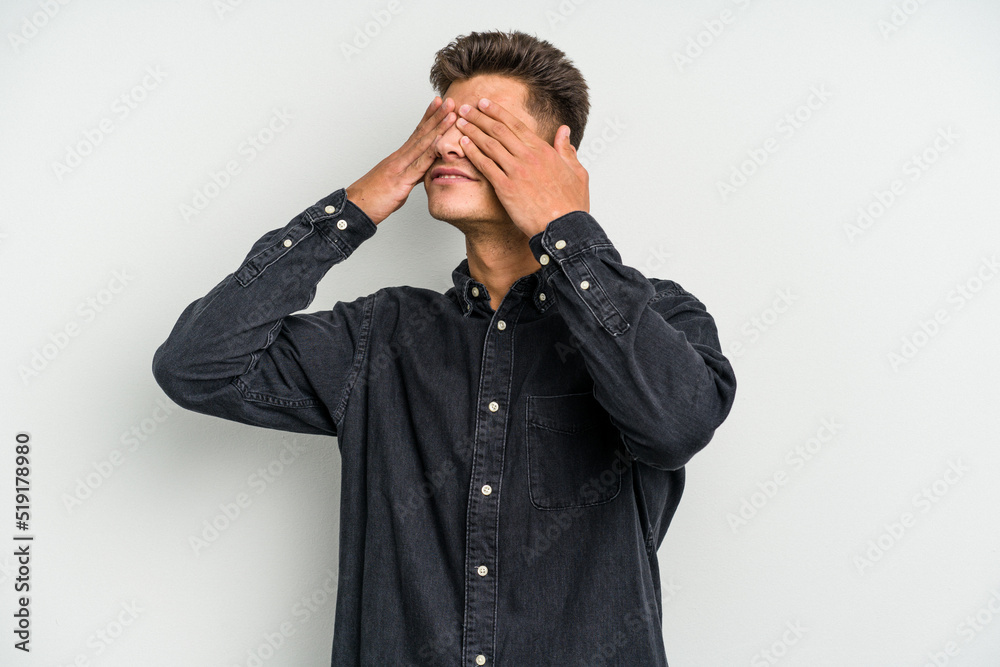 Young caucasian man isolated on white background afraid covering eyes with hands. Young caucasian man isolated on white background afraid covering eyes with hands.
