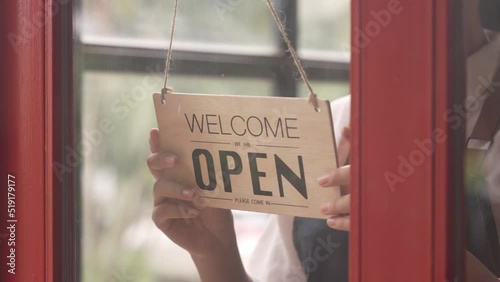 small shop owner Turn the sign wide open through the glass door. ready to serve