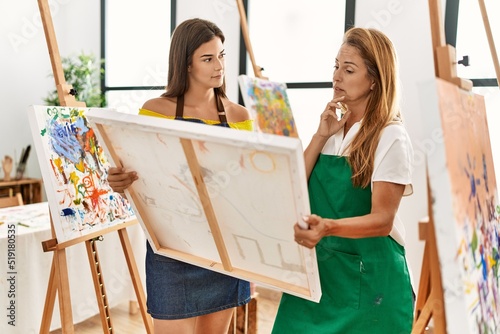 Mother and daughter looking draw canvas at art studio